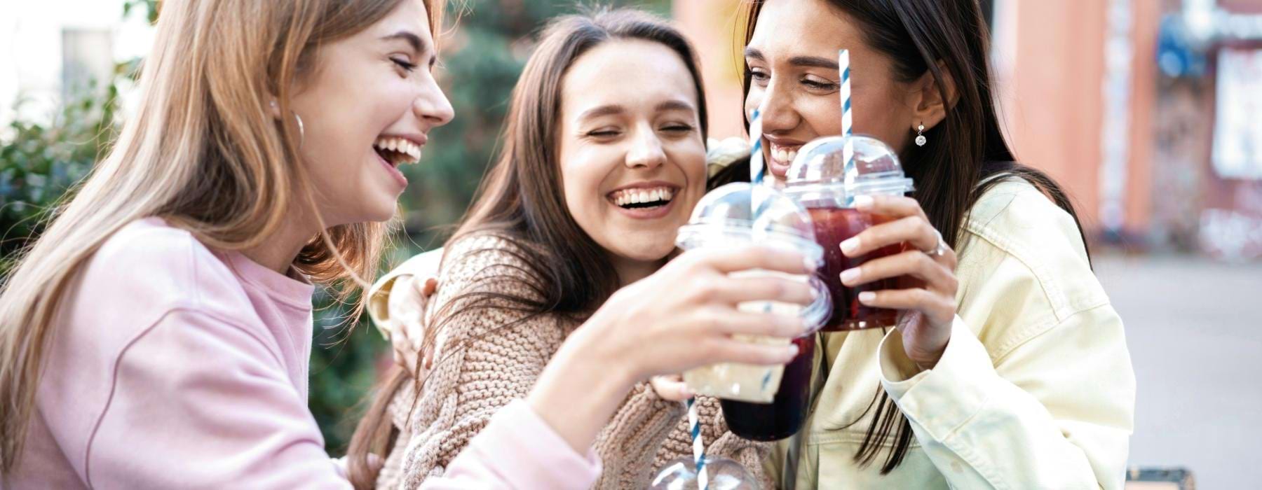 a group of women drinking from cups
