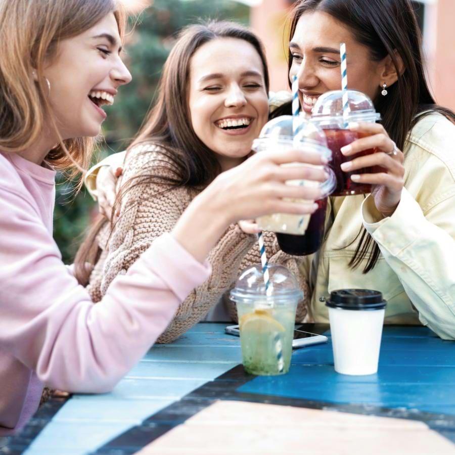 a group of women drinking from cups